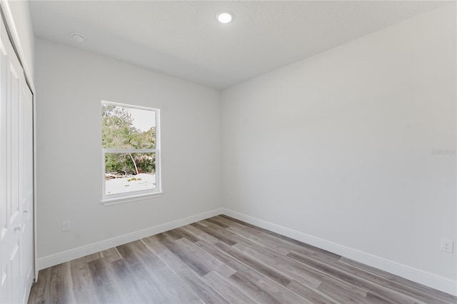 17434 SW 36th Avenue Rd, Ocala, FL 34473 - unfurnished bedroom with light wood-type flooring, baseboards, recessed lighting, and a closet