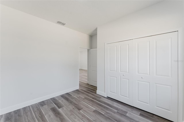 17434 SW 36th Avenue Rd, Ocala, FL 34473 - unfurnished bedroom featuring wood finished floors, a closet, and baseboards
