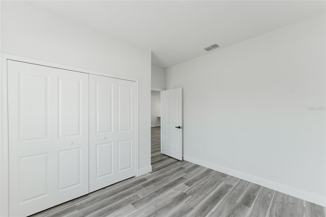 17434 SW 36th Avenue Rd, Ocala, FL 34473 - unfurnished bedroom featuring light wood-type flooring, baseboards, and a closet