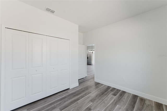 17434 SW 36th Avenue Rd, Ocala, FL 34473 - unfurnished bedroom featuring wood finished floors, baseboards, and a closet