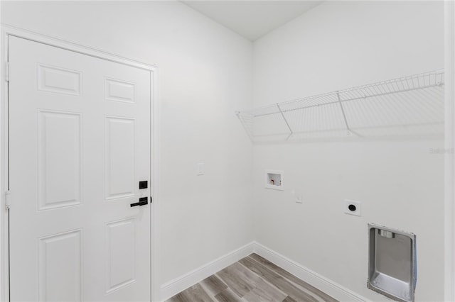 17434 SW 36th Avenue Rd, Ocala, FL 34473 - laundry area featuring electric dryer hookup, hookup for a washing machine, light wood-type flooring, and baseboards