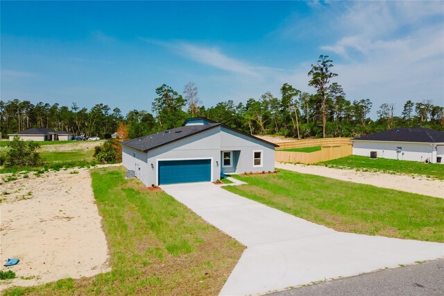 17434 SW 36th Avenue Rd, Ocala, FL 34473 - view of front of home with concrete driveway, a garage, stucco siding, and view of wooded area