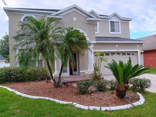 10415 Lucaya Dr, Tampa, FL 33647 - view of front of property featuring a garage, stucco siding, and concrete driveway