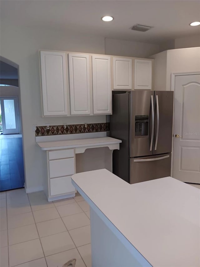 10415 Lucaya Dr, Tampa, FL 33647 - kitchen with stainless steel fridge, white cabinets, light tile patterned flooring, light countertops, and recessed lighting