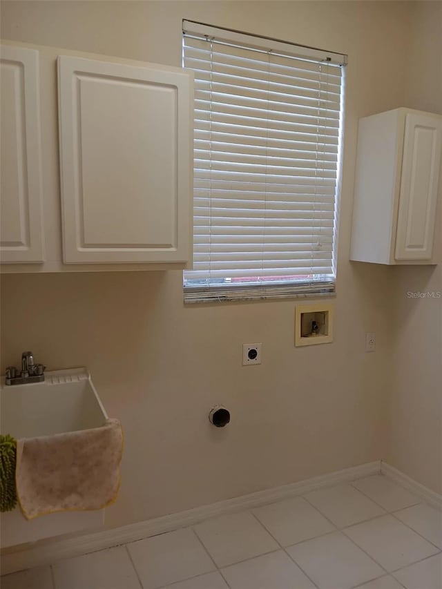 10415 Lucaya Dr, Tampa, FL 33647 - washroom with hookup for an electric dryer, hookup for a washing machine, cabinet space, baseboards, and tile patterned floors