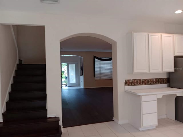 10415 Lucaya Dr, Tampa, FL 33647 - kitchen featuring arched walkways, light countertops, white cabinetry, recessed lighting, and baseboards