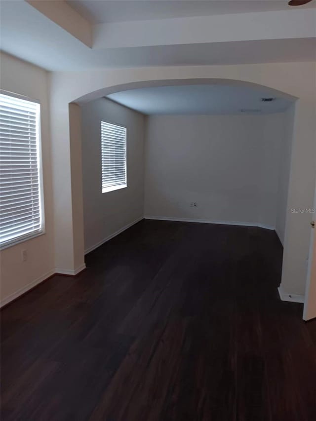 10415 Lucaya Dr, Tampa, FL 33647 - unfurnished room featuring dark wood-style floors, baseboards, and arched walkways