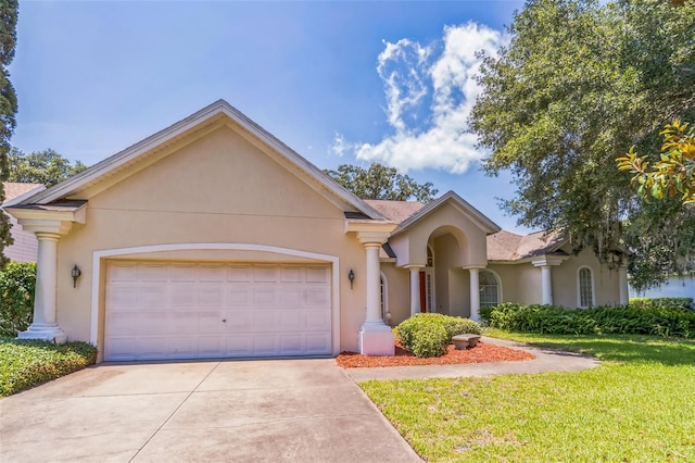 34239 Woodridge Ln, Eustis, FL 32736 - view of front of house featuring stucco siding, an attached garage, driveway, and a front yard