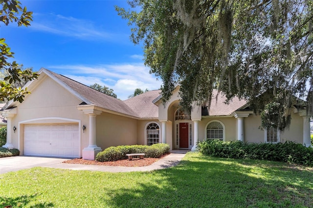 34239 Woodridge Ln, Eustis, FL 32736 - view of front of property with concrete driveway, stucco siding, a front yard, and a garage