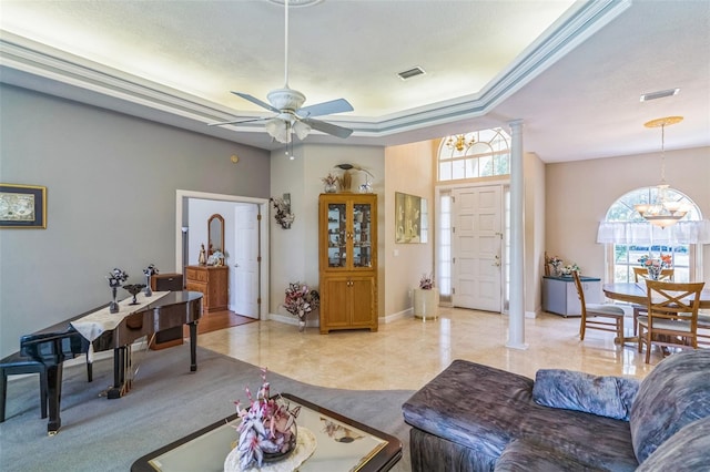 34239 Woodridge Ln, Eustis, FL 32736 - living area featuring a ceiling fan, a chandelier, a tray ceiling, and baseboards