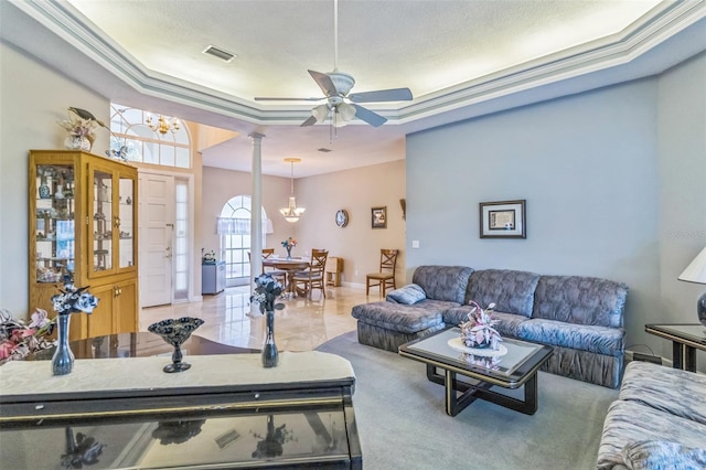 34239 Woodridge Ln, Eustis, FL 32736 - living room with a tray ceiling, decorative columns, ceiling fan, and a chandelier