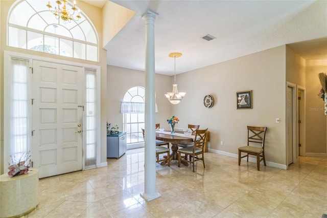 34239 Woodridge Ln, Eustis, FL 32736 - entryway featuring decorative columns, a chandelier, and baseboards