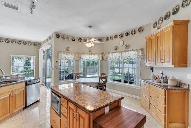 34239 Woodridge Ln, Eustis, FL 32736 - kitchen featuring appliances with stainless steel finishes, a sink, healthy amount of natural light, and light tile patterned floors