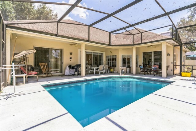34239 Woodridge Ln, Eustis, FL 32736 - swimming pool with a ceiling fan, a patio area, and glass enclosure