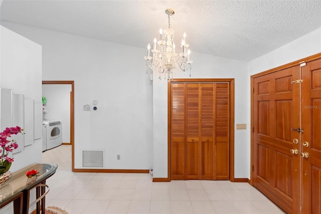 2018 N Normandy Blvd, Deltona, FL 32725 - foyer with washer / clothes dryer, a chandelier, a textured ceiling, vaulted ceiling, and baseboards