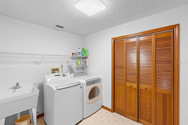 2018 N Normandy Blvd, Deltona, FL 32725 - laundry room with washer and dryer, a textured ceiling, and light floors