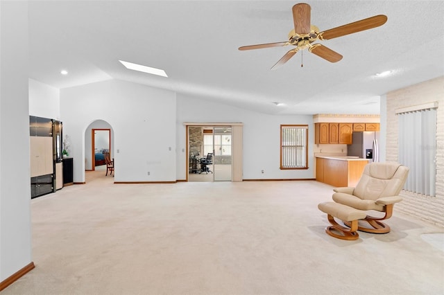2018 N Normandy Blvd, Deltona, FL 32725 - sitting room with light colored carpet, arched walkways, baseboards, lofted ceiling, and ceiling fan