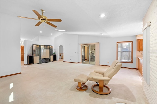 2018 N Normandy Blvd, Deltona, FL 32725 - unfurnished living room featuring light carpet, lofted ceiling, ceiling fan, arched walkways, and baseboards
