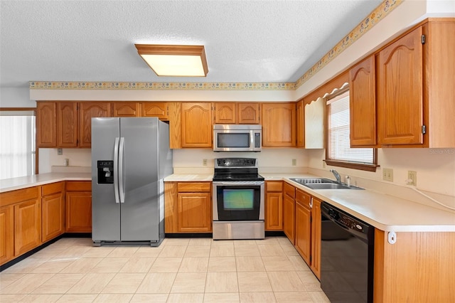 2018 N Normandy Blvd, Deltona, FL 32725 - kitchen with stainless steel appliances, a sink, brown cabinetry, and a textured ceiling