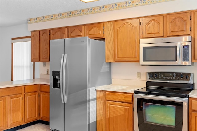 2018 N Normandy Blvd, Deltona, FL 32725 - kitchen with appliances with stainless steel finishes, light countertops, and brown cabinets