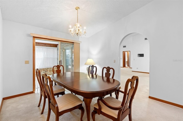 2018 N Normandy Blvd, Deltona, FL 32725 - dining area featuring arched walkways, a chandelier, a textured ceiling, baseboards, and light colored carpet