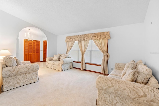 2018 N Normandy Blvd, Deltona, FL 32725 - living room featuring arched walkways, carpet, lofted ceiling, a chandelier, and baseboards