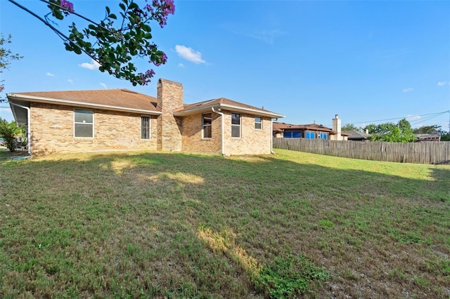 2018 N Normandy Blvd, Deltona, FL 32725 - rear view of property featuring a chimney and brick siding