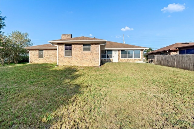 2018 N Normandy Blvd, Deltona, FL 32725 - rear view of house with a chimney and brick siding