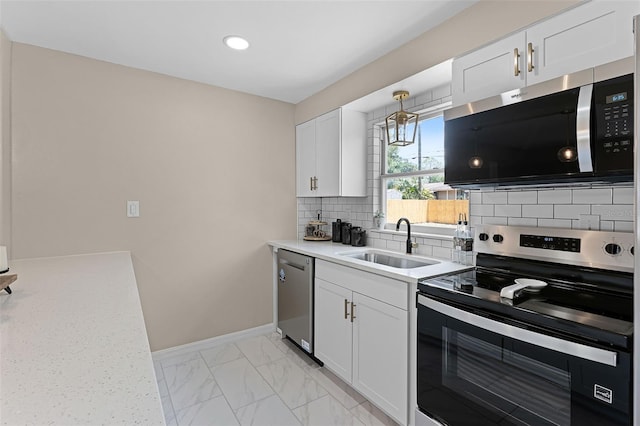 410 W Seminole Ave, Eustis, FL 32726 - kitchen featuring stainless steel appliances, a sink, baseboards, decorative backsplash, and white cabinetry