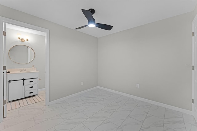 410 W Seminole Ave, Eustis, FL 32726 - unfurnished bedroom featuring light marble finish flooring, a sink, and baseboards
