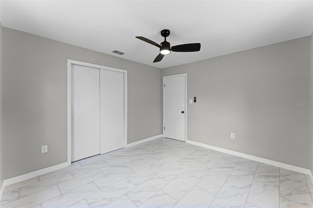 410 W Seminole Ave, Eustis, FL 32726 - unfurnished bedroom with light marble finish floors, baseboards, a closet, and a ceiling fan