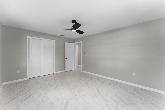 410 W Seminole Ave, Eustis, FL 32726 - unfurnished bedroom featuring light marble finish flooring, baseboards, a closet, and a ceiling fan