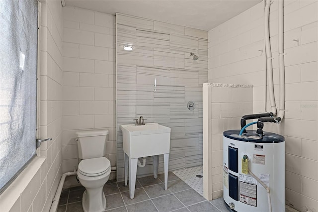 410 W Seminole Ave, Eustis, FL 32726 - full bath featuring electric water heater, walk in shower, toilet, tile walls, and tile patterned floors