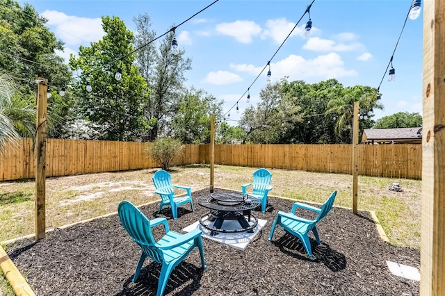 410 W Seminole Ave, Eustis, FL 32726 - fenced backyard featuring an outdoor fire pit
