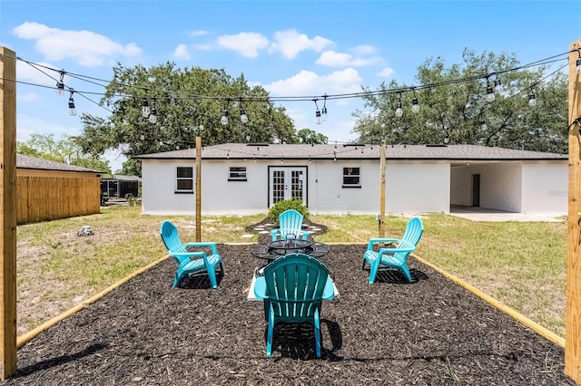 410 W Seminole Ave, Eustis, FL 32726 - back of property featuring french doors, a yard, a fire pit, and a patio