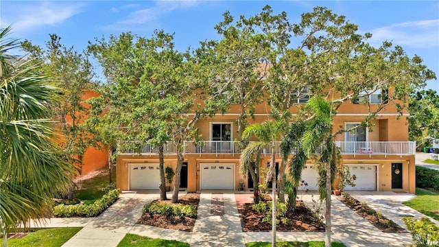 5016 W Lancaster St Unit 00, Tampa, FL 33616 - townhome / multi-family property featuring an attached garage, stucco siding, and driveway