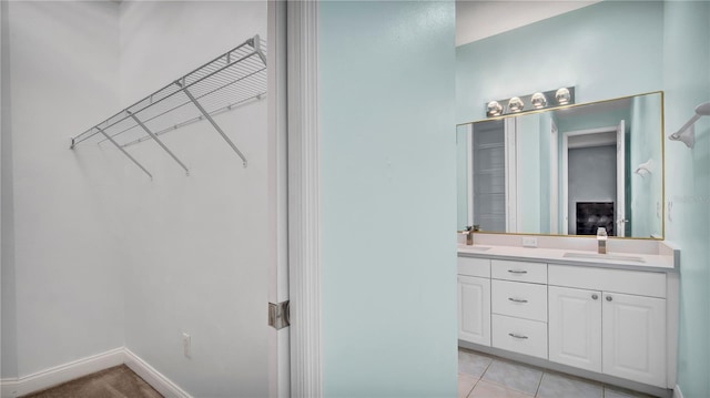 5016 W Lancaster St Unit 00, Tampa, FL 33616 - bathroom with double vanity, baseboards, and tile patterned floors