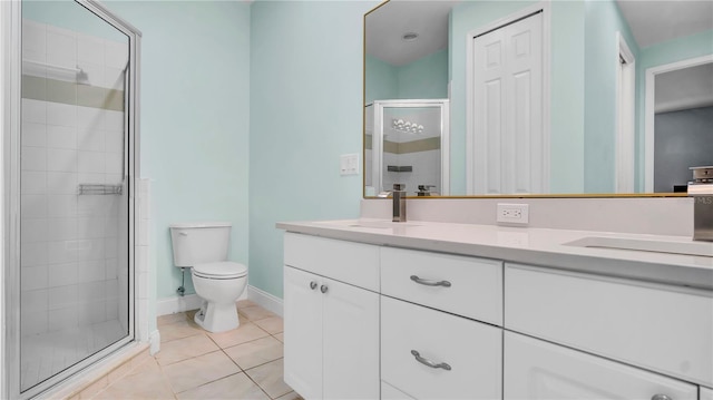 5016 W Lancaster St Unit 00, Tampa, FL 33616 - full bath featuring a shower stall, double vanity, tile patterned flooring, toilet, and baseboards
