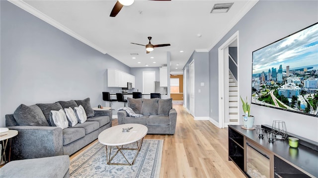 5016 W Lancaster St Unit 00, Tampa, FL 33616 - living area featuring a ceiling fan, light wood-style flooring, ornamental molding, stairway, and baseboards