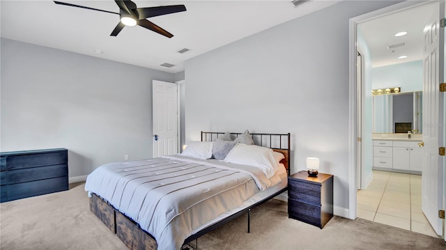 5016 W Lancaster St Unit 00, Tampa, FL 33616 - bedroom with light carpet, baseboards, connected bathroom, ceiling fan, and light tile patterned floors