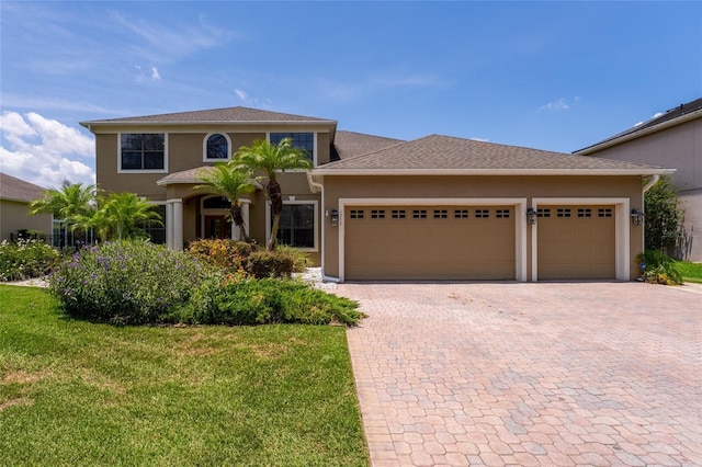 1716 Wild Indigo Ter, Oviedo, FL 32766 - mediterranean / spanish-style home featuring decorative driveway, a garage, stucco siding, and a front yard
