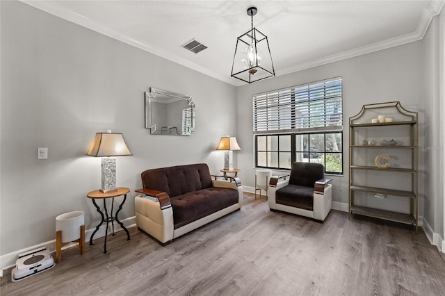 1716 Wild Indigo Ter, Oviedo, FL 32766 - living area with a chandelier, wood finished floors, baseboards, and crown molding