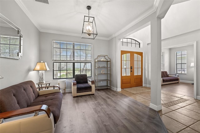 1716 Wild Indigo Ter, Oviedo, FL 32766 - foyer with plenty of natural light, wood finished floors, ornamental molding, a chandelier, and baseboards