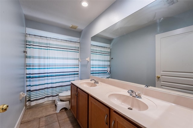 1716 Wild Indigo Ter, Oviedo, FL 32766 - full bath with double vanity, toilet, tile patterned flooring, and a shower with shower curtain