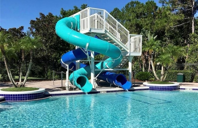 1716 Wild Indigo Ter, Oviedo, FL 32766 - community pool with a water slide, stairs, and view of scattered trees