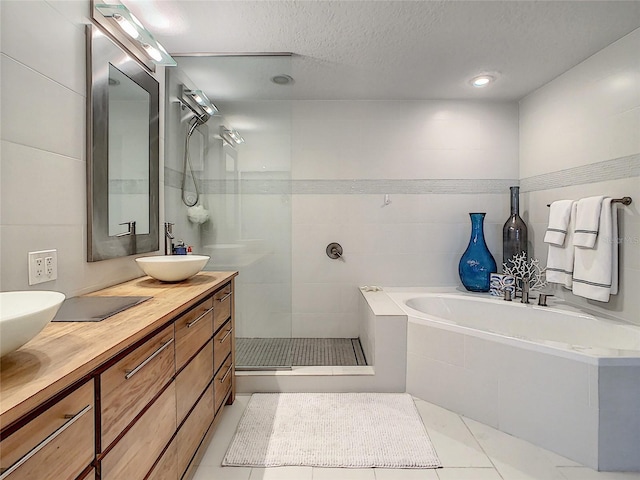 100 S Eola Dr Unit 611, Orlando, FL 32801 - full bath featuring double vanity, a bath, walk in shower, a textured ceiling, and tile patterned floors