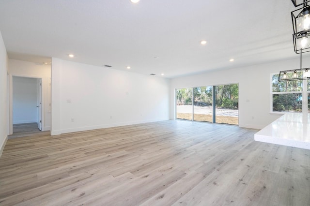 509 St Johns Ct, Poinciana, FL 34759 - unfurnished room with baseboards, light wood finished floors, and recessed lighting