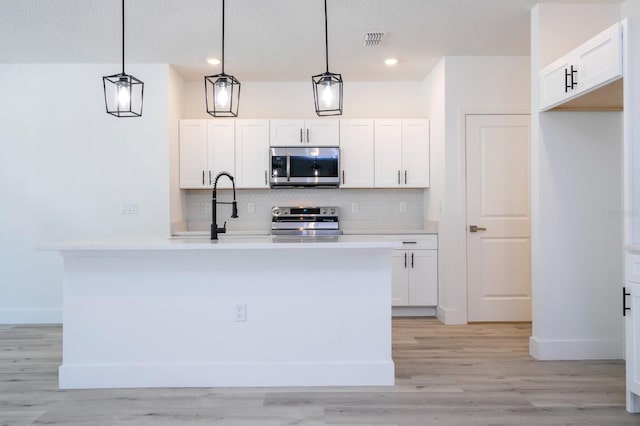 509 St Johns Ct, Poinciana, FL 34759 - kitchen featuring stainless steel appliances, backsplash, white cabinets, baseboards, and recessed lighting