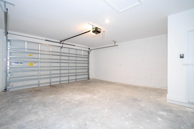 509 St Johns Ct, Poinciana, FL 34759 - garage featuring concrete block wall and a garage door opener