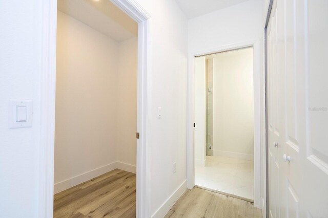 509 St Johns Ct, Poinciana, FL 34759 - hallway featuring light wood-style flooring and baseboards